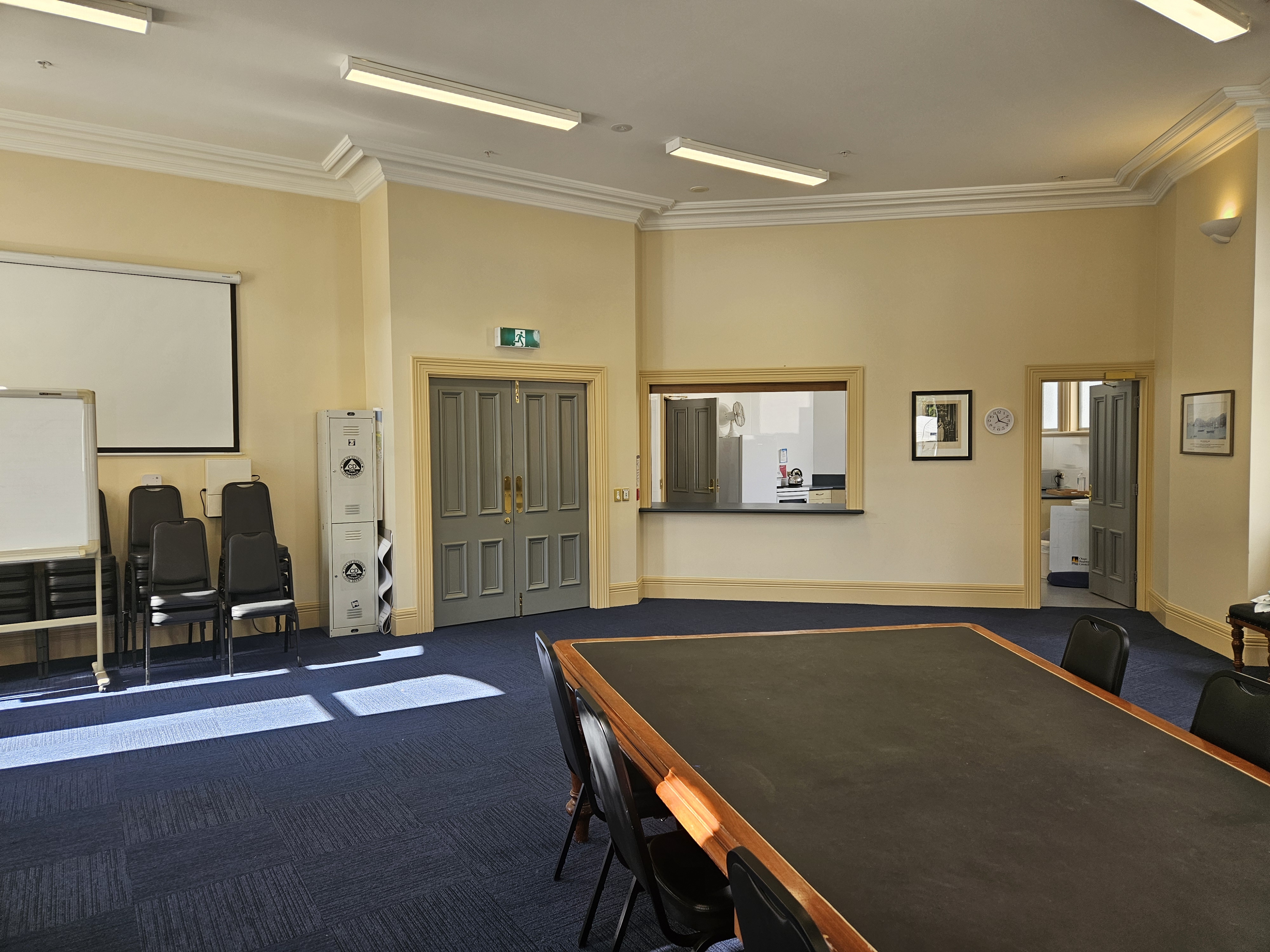 A meeting room with an adjacent kitchenette